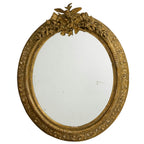 Miroir ovale français doré, sculpté d'un oiseau armorié, vers 1900